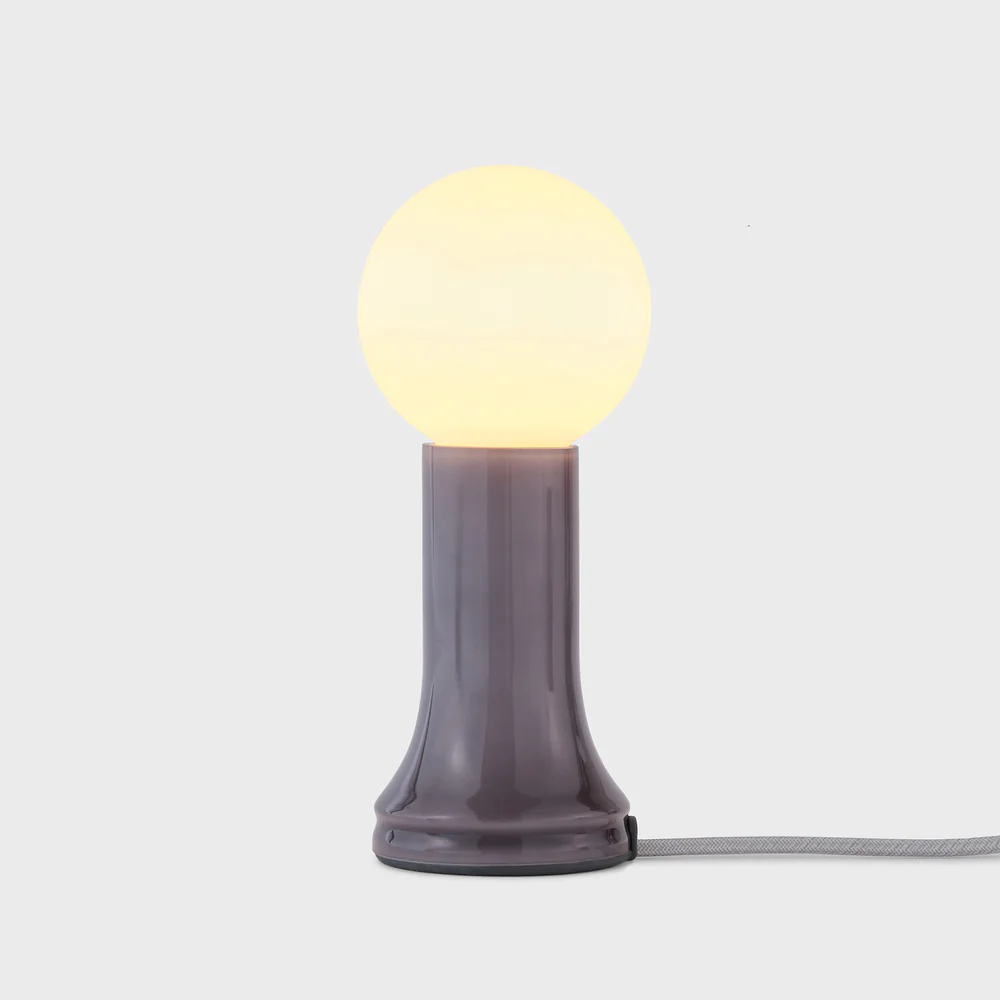 Decorative table lamp with G95 bulb included, 3 6/8" length x 3 6/8" width x 8 7/8" height, 6W, E26 base, Smoke Grey finish. Includes dimmer, 110-120V, Damp Location, recycled glass construction, 2-year warranty.